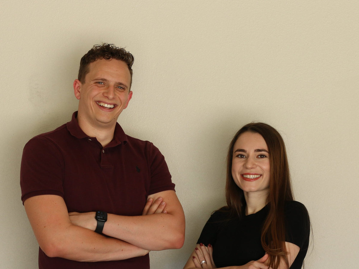 Carson and Mari Hawkins, the founders of UNDR CO, smiling with arms crossed